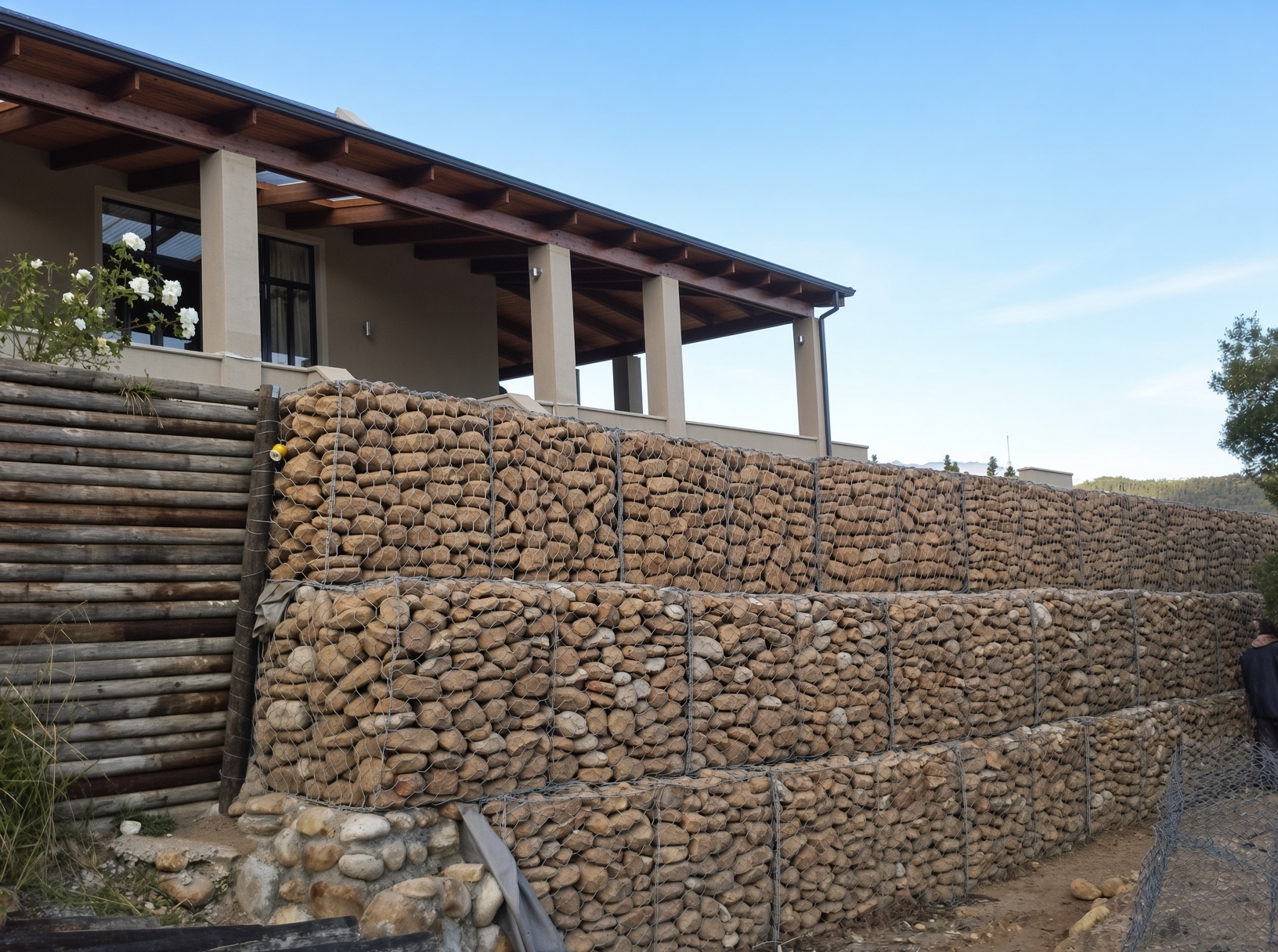 Gabion retaining wall filled with natural river stones by CSA Landscaping, professional hardscaping specialists in the Boland and Cape Winelands, Franschhoek estate.