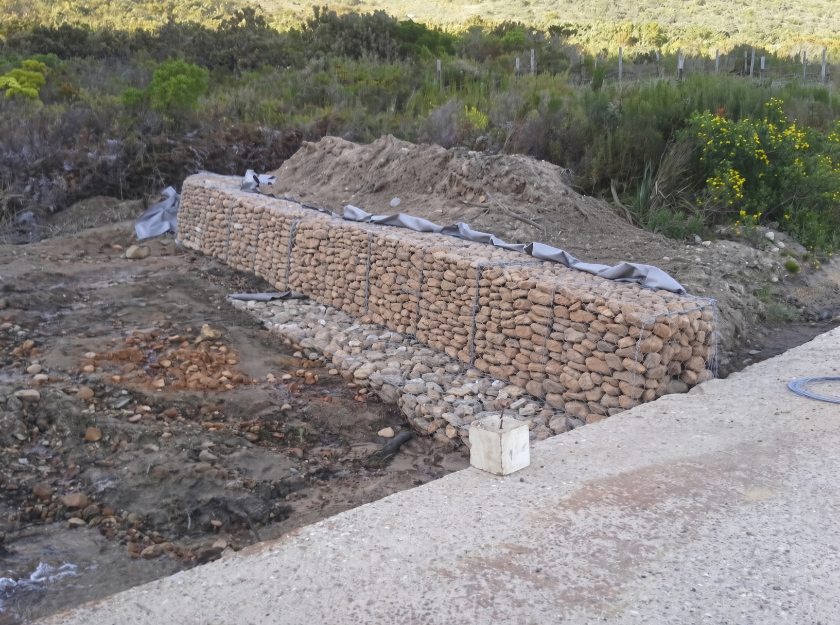 Gabion retaining wall filled with natural river stones by CSA Landscaping, professional hardscaping specialists in the Boland and Cape Winelands, Franschhoek estate.