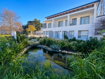 Formal pond with rock edging and ornamental planting by CSA Landscaping, the best in Boland and Cape Winelands landscaping, at Hugenote Hotel Franschhoek
