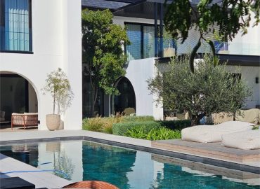 Poolside seating with mature olive trees and soft planting by CSA Landscaping, leading precision landscapers in the Boland and Cape Winelands, The Acres at Pearl Valley. CSA Landscaping