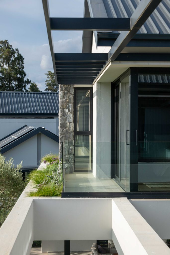 Upper balcony planter with ornamental grasses and flowering perennials beside glass balustrade at Val de Vie Estate, Paarl, by CSA Landscaping — leading landscapers in the Boland and Cape Winelands