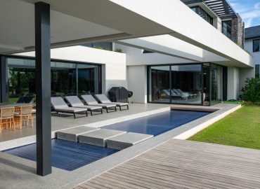 Pool and outdoor living terrace flowing into the lawn garden at a contemporary home in Val de Vie Estate, Paarl, by CSA Landscaping — leading landscapers in the Boland and Cape Winelands